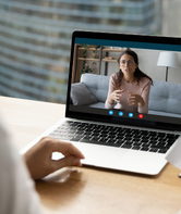 Laptop displaying a person talking on a virtual call.